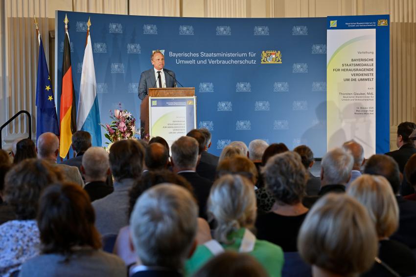Umweltminister Thorsten Glauber steht am Rednerpult und hält eine Festrede.